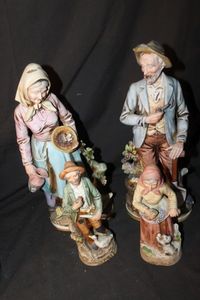 lot 224 image: Four Vintage Porcelain Homco Figurines Woman with Grapes and dog Model 1417, Elderly man in a green jacket holding a pipe and knife with a goose model 1417, Old World Farmer Elderly man with a shovel and pipe Old Woman with Basket model 8816