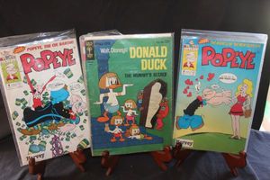 lot 233 image: Three Vintage Comic Books Popeye by Harvey Comics, Donald Duck The Mummys Secret Gold Key issue 10037-503, Popeye by Harvey Comics.