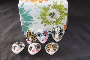 lot 249 image: Six small decorative porcelain masquerade mask figurines with decroative box