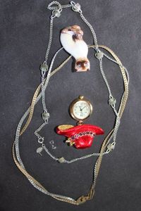 lot 267 image: Sara Covington Necklace, Red Hat Society Pendant Watch and Avon Siamese Cat Pendant. Gold tone necklace.