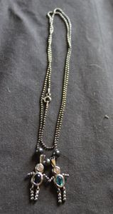 lot 254 image: Y2K Style necklace featuring Sterling Silver boy and girl charms with set birthstones. Necklace stamped 925 Italy, charms both stamped 925
