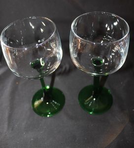lot 277 image: Two Luminarc French Green Stem wine glasses featuring clear rounded bowl and distinct emerald, green stem and foot