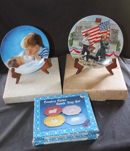 lot 282 image: Two Vintage Collectible Plates, featuring artwork by Norman Rockwell, and Country Calico Bosch Try Set in original box (1 set of 3 trays)