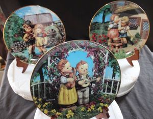 lot 285 image: Three Collectible Vintage Hummel Plates with certificate of authenticity, M.I. Hummel Little Companions by Danbury Mint, Little Musicians and Squeaky Clean (Stands not included)