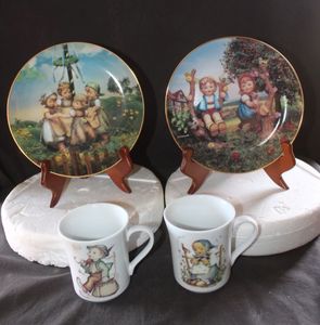 lot 286 image: Two Collectible Danbury Mint Plates Apple Tree Boy and Girl and Maypole and Two M.J. Hummel Mugs The Merry Wanderer and He Loves Me