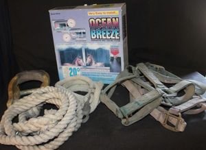 lot 328 image: DIG Ocean Breeze Evaporative Mist Cooling System, designed to cool patios, greenhouses, or animal areas by reducing air temperature, in original box. Vintage rawhide-covered western horse saddle stirrups. Training lead rope, and horse tackbridle.