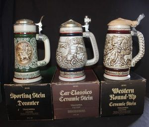 lot 301 image: Three Vintage Avon Collectible Beer Stiens Featuring Pewter Lids, Sporting Stein, 1978, Car Classics Ceramic Stein and Western Round-Up Cattle Drive Stein 1980 with Original boxes&nbsp