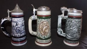 lot 326 image: Three Vintage collectible beer steins produced by Avon, handcrafted in Brazil by Cremarte featuring pewter lids.