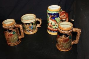 lot 325 image: Four Vintage Collectible German-style beer steins, see below for more details