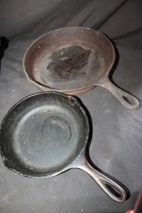 lot 306 image: Two Cast Iron Frying Pans, Lodge Brand 5 inch and unknown 8 inch