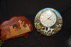 lot 337 image: Pair of collectible wooden marquetry scene plaquefolk art and a decorative round cow clock
