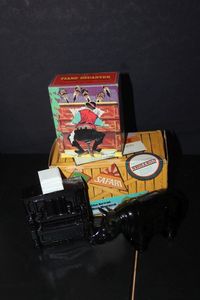 lot 363 image: Two Vintage Avon Decanters with Original boxes Piano Glass bottle with plastic cap. and Rhino Glass bottle,