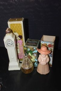 lot 376 image: Three Avon Decanter bottles with oirginal boxes. Milk glass Grandfather Clock, Clear Glass Pear, and Little Kate peach colored woman wearing a hat with boxes.