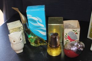 lot 377 image: Four Vintage Avon decanter bottles, Milk glasses owl, Bird, Perfume bottle and Red and silver bird all have original boxes