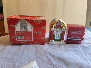 lot 16 image: Lot of 3 vintage Coca Cola - Coke themed items - ice chest themed toothpick dispenser, 1995 Enesco Coca Cola Country - Hook, Line, and Sinker - Bait Shop, and jukebox themed salt & pepper shaker set