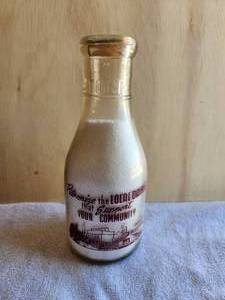 lot 18 image: Vintage glass quart milk bottle - E. Schwenk Dairy - with rare Rikers milk cap