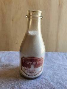 lot 100 image: Vintage glass milk bottle -Carnation Dairy Products - with rare Meibaum Bros. milk cap