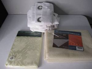lot 24 image: New 5x7 Area Rug Pad, New Damask Tablecloth an Used White Curtains.