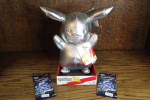 lot 93 image: Pokmon 25th Anniversary Silver Pikachu Plush and factory-sealed Korean Pokmon Trading Card Game