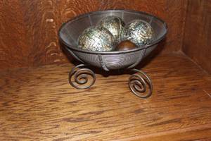 lot 107 image: decorative wire basket centerpiece with spheres and dark orbs.