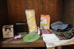 lot 215 image: Pa k of cleaning gloves tissue boxs glass measuring spoons and glass cutting board and more see pictures