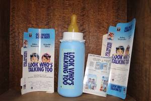 lot 222 image: collectible blue baby bottle bank designed with the branding for the 1990 film Look Whos Talking Too