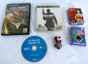 lot 11 image: PS3 Call of Duty, PS2 Star Wars Starfighter, Wii Sports, Mario cart race car and playing cards