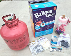 lot 23 image: Balloon time helium tank& balloons, plus party favorites