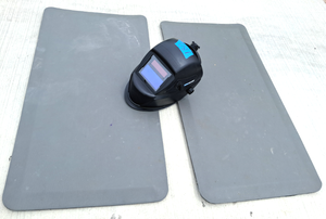 lot 180 image: Chicago Electric welding helmet solar charging lens, plus two padded anti-fatigue floor mats