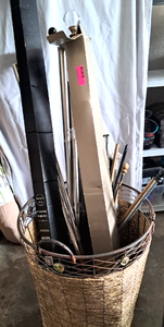 lot 109 image: Large wicker basket full of assorted curtain rods