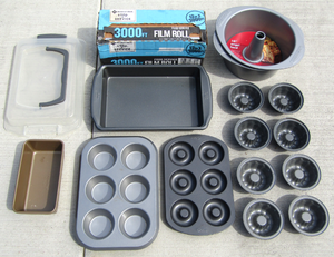 lot 45 image: Baking pans never used some with labels still on, plus large roll of clear film wrap