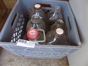 lot 93 image: Vollemans milk bottles in gray crate