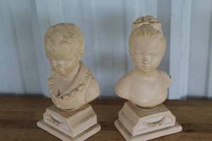 lot 11 image: busts depicting a young boy and girl book ends