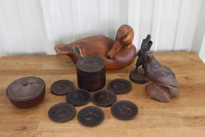 lot 14 image: collection of vintage rustic wooden items likely includes decorative coasters, a small container, and carved sculptures