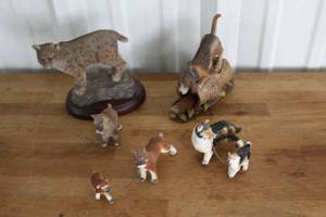 lot 16 image: bobcat figurine and dog with fox in a tree trunk figurine,and dog figurines