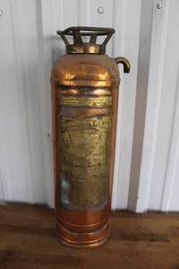 lot 26 image: vintage RED STAR model 303 fire extinguisher, characterized by its copper construction with brass detailing.