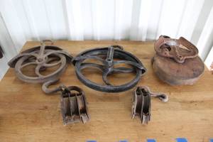 lot 49 image: antique cast iron and wood pulleys