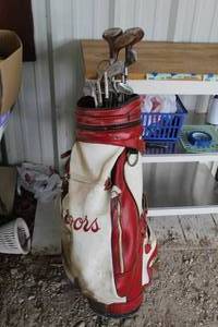 lot 100 image: vintage Coors brand golf bag filled with antique-style golf clubs.  See pictures took pictures of them all