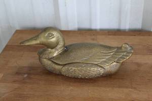 lot 115 image: vintage duck decoy featuring a hidden storage compartment