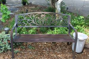 lot 482 image: rustic metal garden bench featuring a decorative cast iron backrest with a scroll or vine pattern