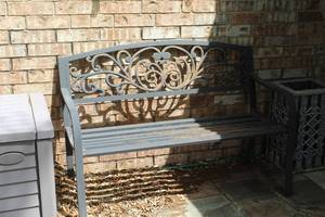 lot 484 image: rustic metal garden bench featuring a decorative cast iron backrest with a scroll or vine pattern
