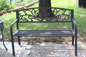 lot 485 image: rustic metal garden bench featuring a decorative cast iron backrest with a scroll or vine pattern