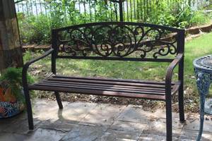lot 486 image: rustic metal garden bench featuring a decorative cast iron backrest with a scroll or vine pattern