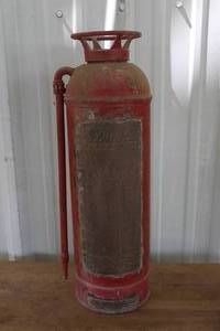 lot 556 image: vintage red fire extinguisher, likely from the early to mid-20th century