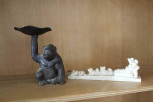 lot 629 image: bronze monkey sculpture with a dish and  Eskimo carving featuring