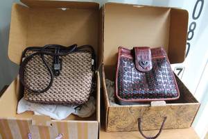 lot 677 image: Brighton woven straw or jute crossbody bag and Brighton black and brown woven leather crossbody handbag