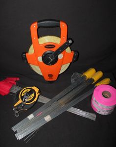 lot 26 image: Keson Ultra-Glass Fiberglass 200ft. measureTape Open Type Reel and Three Roles of Empire Brand Fluorescent Pink Flagging Tape, Approximately 300 Presco Yellow Marking Flags. Dewalt 100ft Closed Case Steel Long Tape Measure, and 100 red marking flags