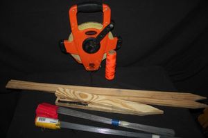 lot 29 image: Keson OTR Series Long Fiberglass Tape Measure and red Marking Flags and Wooden spikes