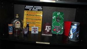lot 176 image: Team Swag and shot glasses collectable bottle and plaque