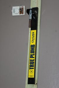 lot 192 image: ChrisNik True Plumb surveying tool calibration tool, will need tools and&nbsp ladder to take off wall